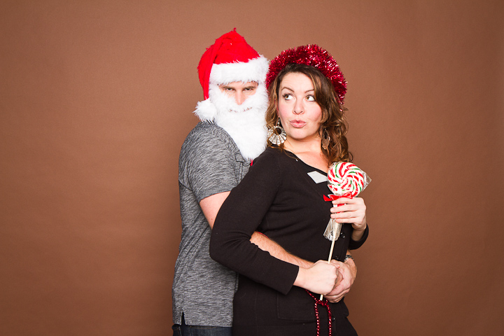 Flirtatious couple posing for Christmas portrait