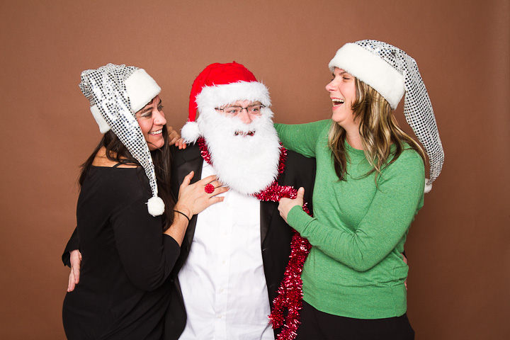 Friends laughing at Egg-Snogger Christmas party photo booth