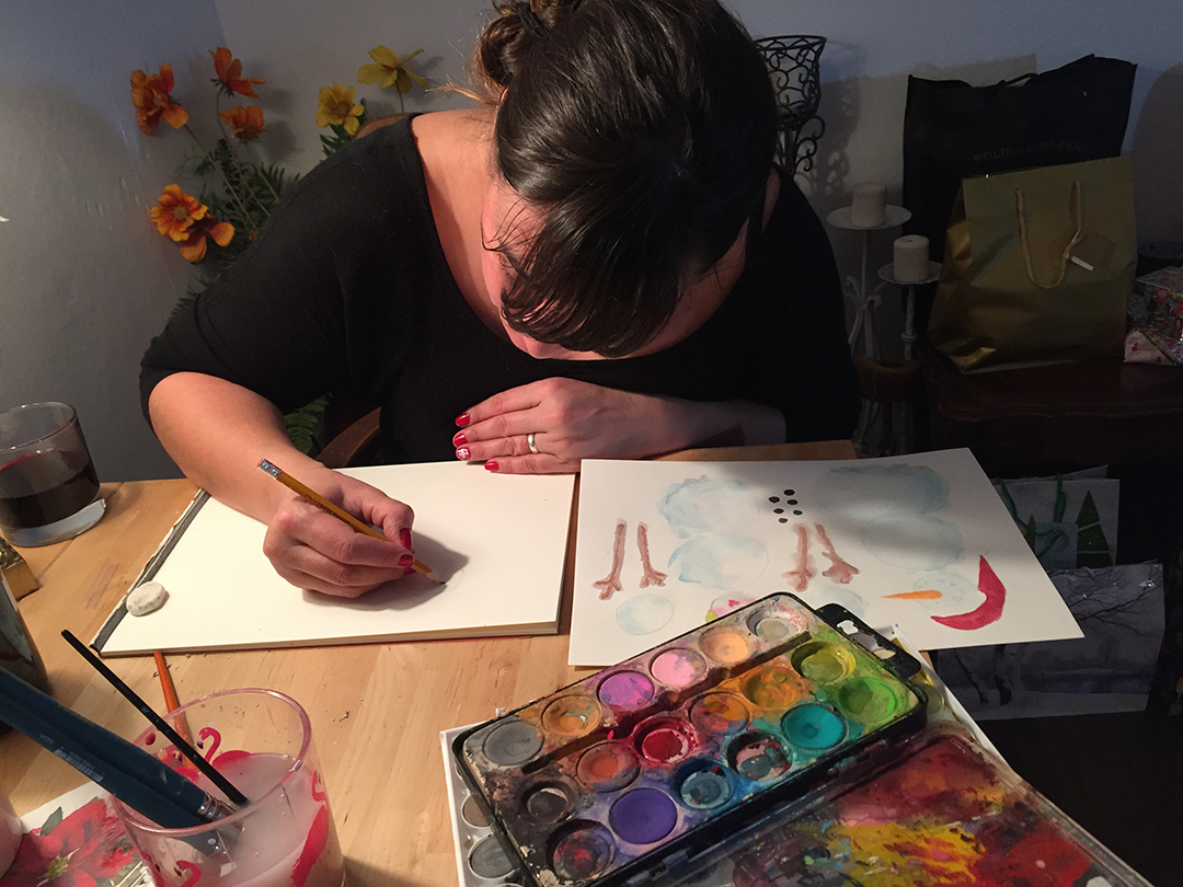 Marina LeClair designing the characters for a virtual Christmas card